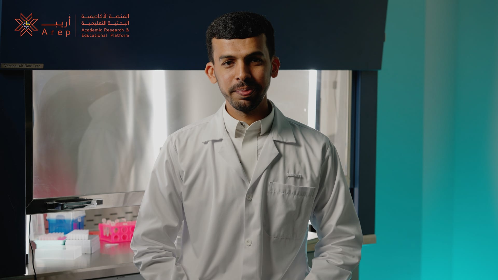A researcher presenting data on a large interactive display in a laboratory.